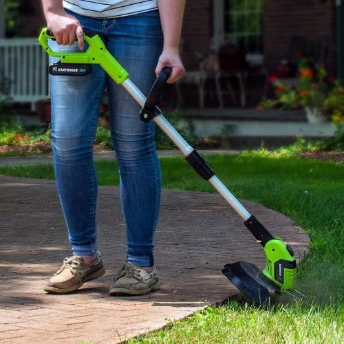 lightweight weed eater trimming lawn